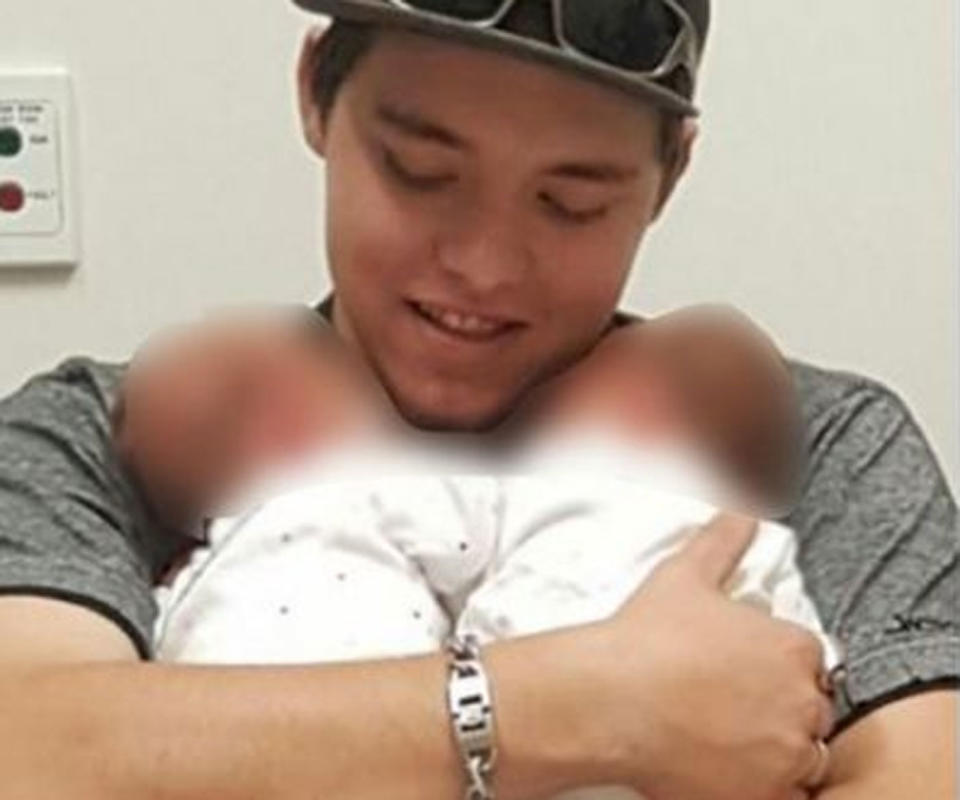 Sterling Mervyn Free, 27, pictured holding two babies.