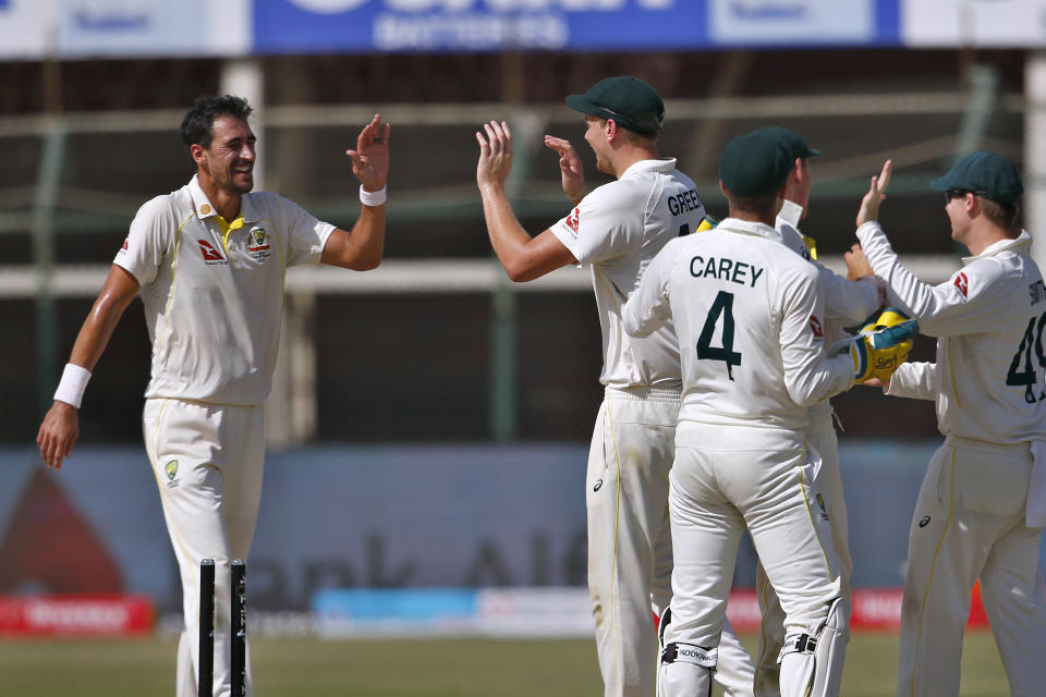 Australia's Mitchell Starc, left, and teammates celebrate after dismissal of Pakistan Hasan Ali on the third day of the second test match between Pakistan and Australia at the National Stadium in Karachi, Pakistan, Monday, March 14, 2022. (AP Photo/Anjum Naveed)