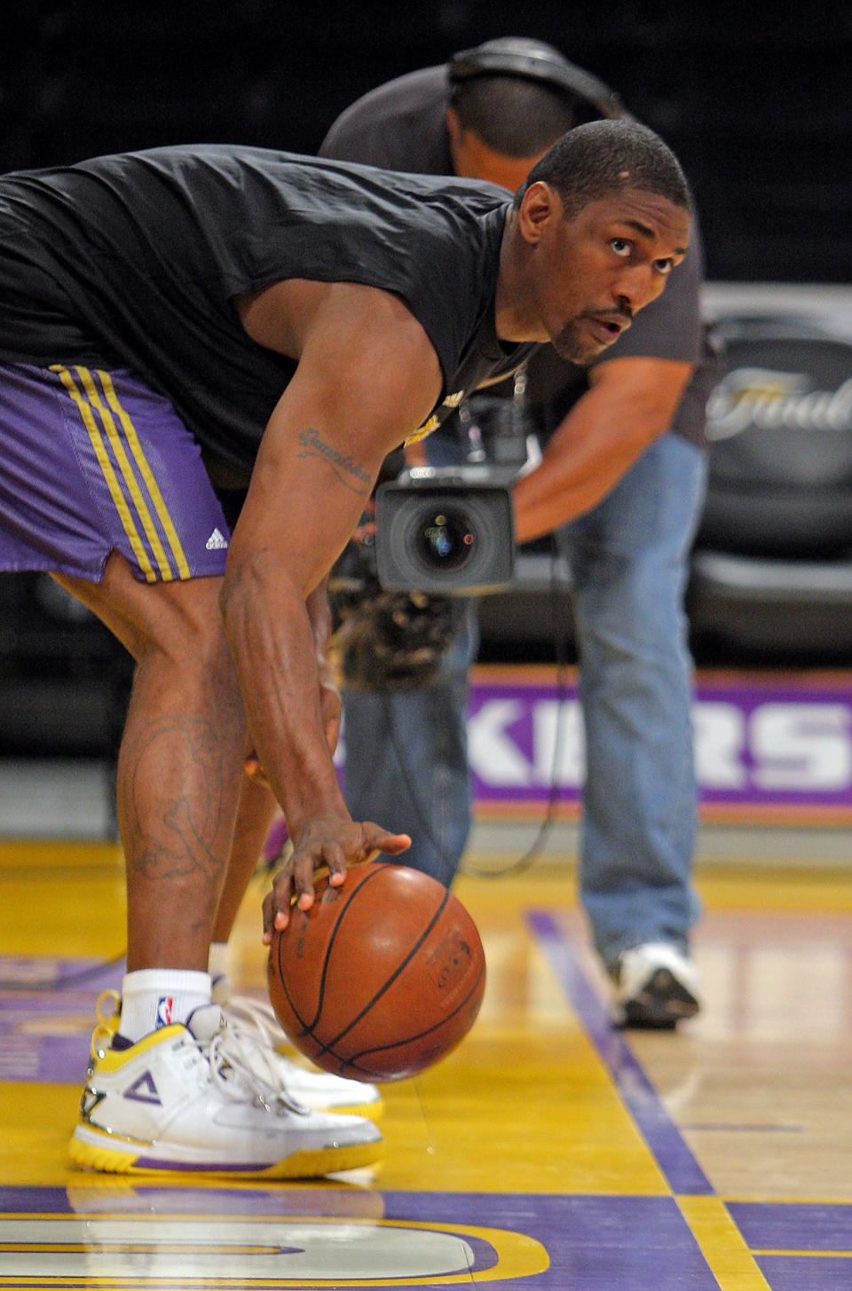 Metta World Peace warms up on a basketball court.