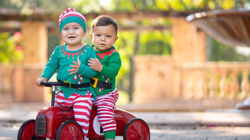 kids dressed as santas helpers in a park