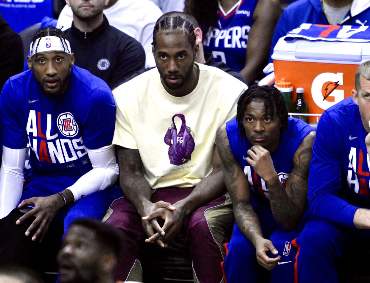 Los Angeles Clippers forward Kawhi Leonard, center, looks on from the bench in street clothes against the Phoenix Suns during Game 3 of a first-round NBA playoff series at the Crypto.com Arena in Los Angeles on April 20, 2023. (Keith Birmingham/MediaNews Group/Pasadena Star-News via Getty Images)