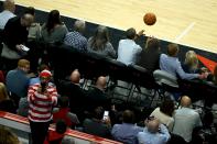 U.S. President Barack Obama (top, 4th R) throws the ball to fans acoss the arena during a timeout in an NBA opening night game between the Cleveland Cavaliers and the Chicago Bulls in Chicago October 27, 2015. Earlier Tuesday Obama delivered remarks at an International Association of Chiefs of Police (IACP) conference and attended Democratic Party events in Chicago. REUTERS/Jonathan Ernst