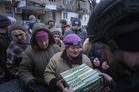 Local residents receive humanitarian aid from the volunteer organization "Chaplain Battalion Mariupol" in Siversk, Donetsk region, Ukraine, Thursday, Jan. 12, 2023. (AP Photo/Evgeniy Maloletka)