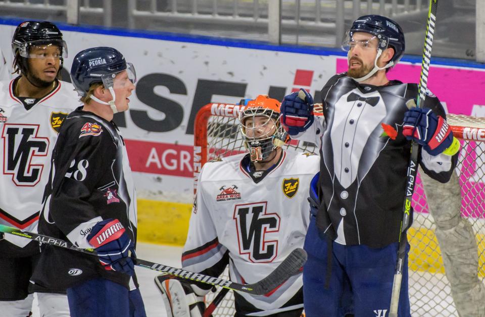 Mitch McPherson of the Rivermen pretends to rip open his tuxedo jersey after scoring Peoria's third goal in the final minutes of the third period Saturday, Jan. 15, 2022 at Carver Arena. The Rivermen defeated the Bobcats 3-1.