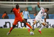 Costa Rica's Cristian Gamboa (R) fights for the ball with Bruno Martins Indi of the Netherlands during their 2014 World Cup quarter-finals at the Fonte Nova arena in Salvador July 5, 2014. REUTERS/Sergio Moraes