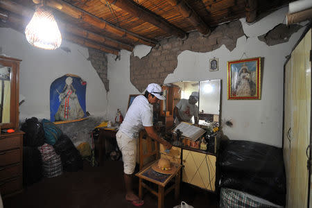 A woman is seen in a building after a strong magnitude 7.1 earthquake struck the coast of southern Peru, in Acari, Arequipa , Peru, January 14, 2018. REUTERS/Diego Ramos