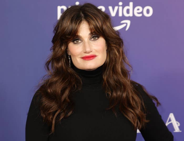 Idina wears a black turtleneck to a premiere