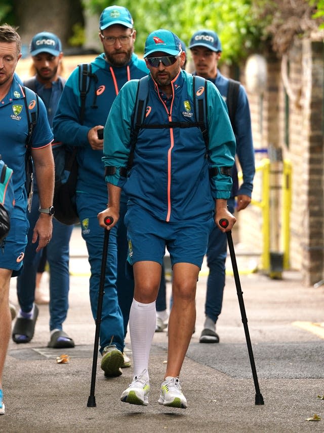 Nathan Lyon hobbles into Lord's on crutches.