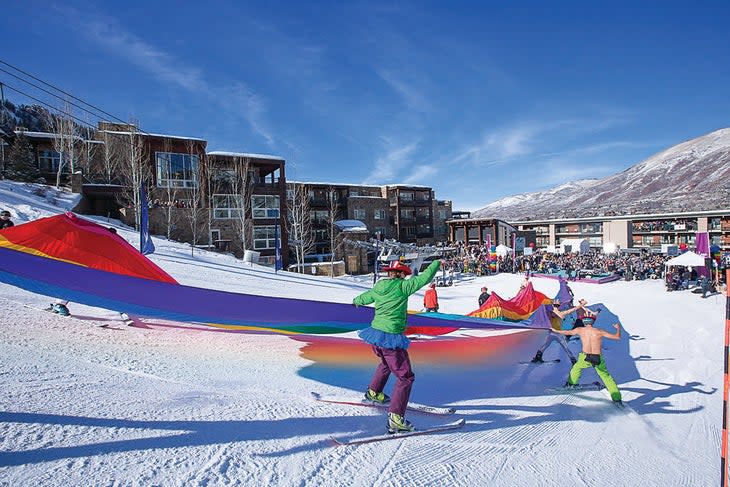 Skiers with a rainbow flag at Aspen Mountain