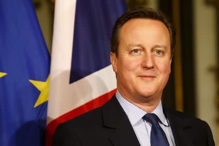 Britain's Prime Minister David Cameron poses for a photo before the traditional historic banquet "Matthiae-Mahlzeit" (St. Matthew's Day Banquet) at the town hall in Hamburg February 12, 2016. REUTERS/Morris Mac Matzen