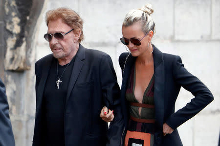 FILE PHOTO: French singer and actor Johnny Hallyday (L) and his wife Laeticia attend the funeral ceremony of late actress Mireille Darc at the Saint-Sulpice church in Paris, France, September 1, 2017. REUTERS/Charles Platiau/File Photo