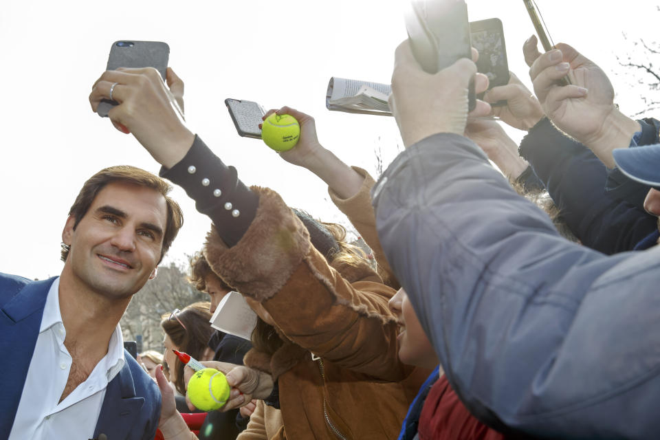 Switzerland's Roger Federer, left, poses for a selfie with supporters, during a pre-event of the Laver Cup, in Geneva, Switzerland, Friday, February 8, 2019. (Salvatore Di Nolfi/Keystone via AP)