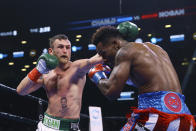 Ireland's Dennis Hogan punches Jermall Charlo during the fifth round of a WBC middleweight title boxing match Saturday, Dec. 7, 2019, in New York. (AP Photo/Michael Owens)