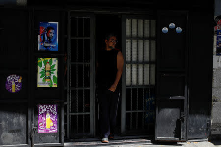 A man walks out a grocery store during an ongoing blackout in Caracas, Venezuela March 10, 2019. REUTERS/Marco Bello