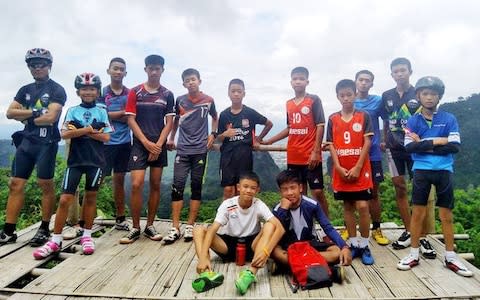 The coach pictured with the boys before they were stranded underground. They play for a team called Moo Pa ( Wild Boar). - Credit: Facebook