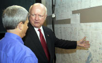 FILE – Samuel Bodman, U.S. Energy Secretary under President George W. Bush, right, visits a transmission control room alongside Georgia Power Co. transmission system operations manager Jeff Stansell at Georgia Power Co. headquarters, in Atlanta on Aug. 4, 2006. Bodman and the Bush administration supported efforts to build new nuclear reactors, including two new reactors at Georgia Power’s Plant Vogtle. (AP Photo/Gene Blythe, File)