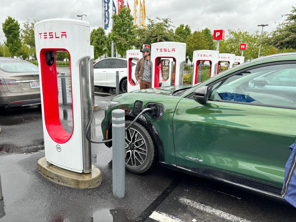 2024 Ford Mustang Mach-E electric vehicle charging at a Seattle-area Tesla DC charger.