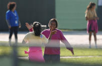 Two girls give high-fives as they play soccer at the Homestead Temporary Shelter for Unaccompanied Children, Tuesday, Feb. 19, 2019, in Homestead, Fla. (AP Photo/Wilfredo Lee)