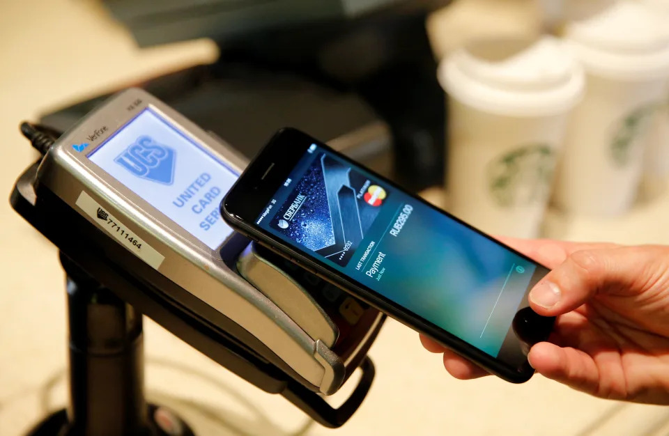 A antheral   uses an iPhone 7 smartphone to show  the mobile outgo   work  Apple Pay astatine  a cafe successful  Moscow, Russia, connected  October 3, 2016. REUTERS/Maxim Zmeyev