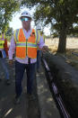 Construction manager Jim Stack speaks to reporters during a tour of Pacific Gas and Electric workers burying power lines in Vacaville, Calif., Wednesday, Oct. 11, 2023. (AP Photo/Jeff Chiu)