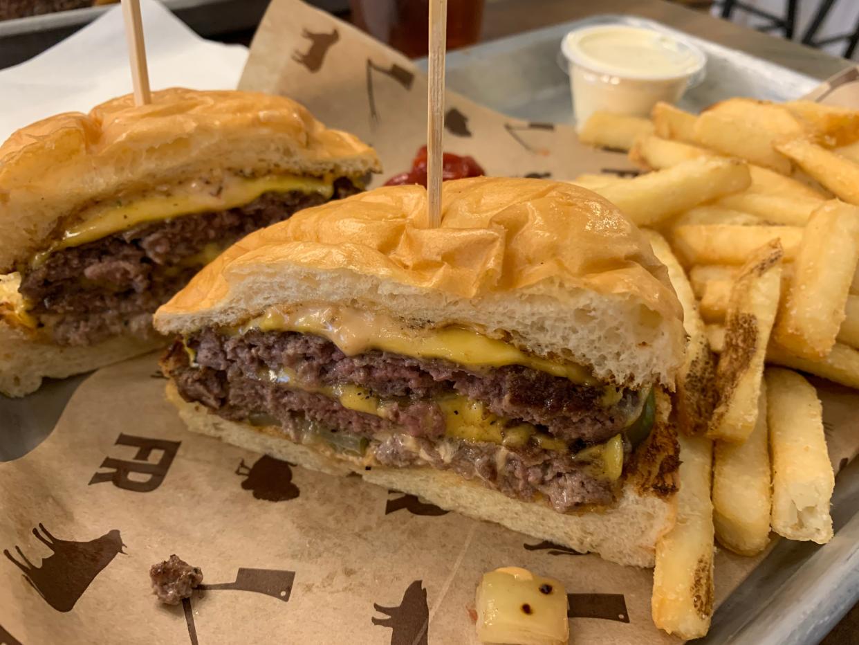 The T-F-R burger at the Farmer's Rail in Cuyahoga Falls features two beef patties, American cheese, caramelized onions, house burger sauce and homemade pickles on a brioche bun.