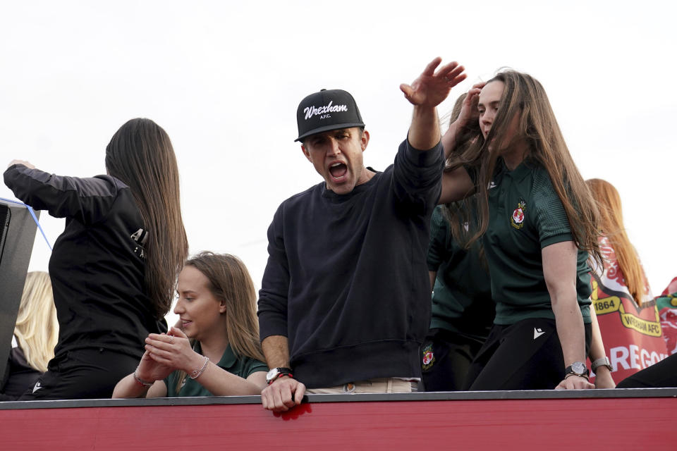 Wrexham Co-Owner, Rob McElhenney celebrates with members of the Wrexham FC soccer team the promotion to the Football League in Wrexham, Wales, Tuesday, May 2, 2023. (Martin Rickett/PA via AP)