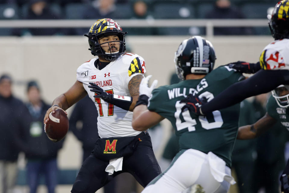 Maryland quarterback Josh Jackson, left, looks to throw against Michigan State's Kenny Willekes during the first half of an NCAA college football game, Saturday, Nov. 30, 2019, in East Lansing, Mich. (AP Photo/Al Goldis)