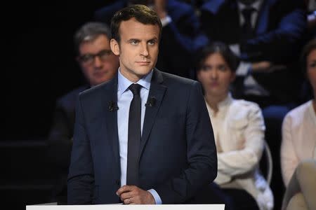 FILE PHOTO: Emmanuel Macron of the political movement En Marche ! (Onwards !) attends a prime-time televised debate for the candidates at French 2017 presidential election in La Plaine Saint-Denis, near Paris, France, April 4, 2017. REUTERS/Lionel Bonaventure/Pool