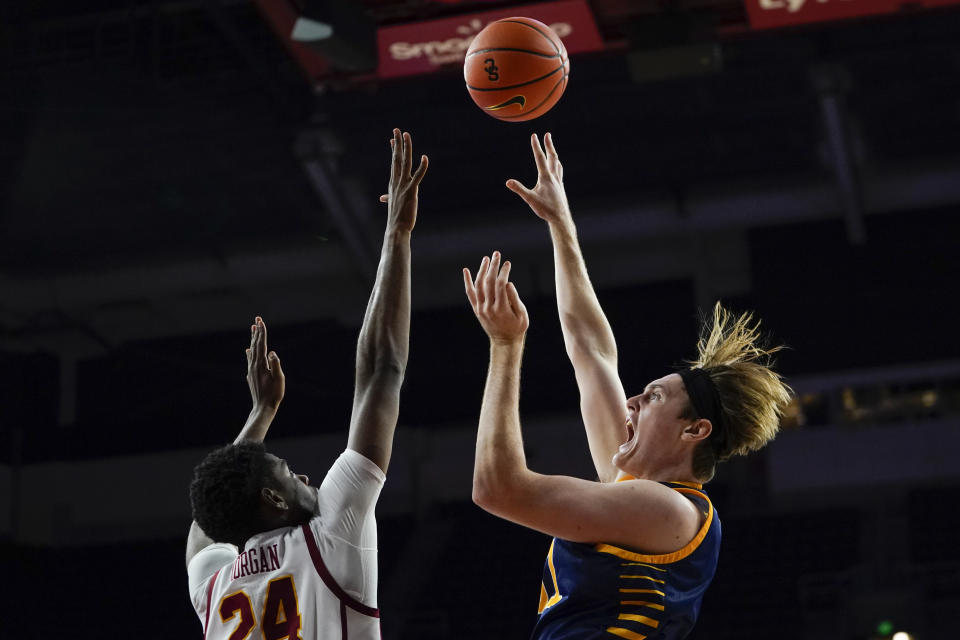 UC Irvine forward Dean Keeler, right, shoots against Southern California forward Joshua Morgan during the second half of an NCAA college basketball game Tuesday, Nov. 14, 2023, in Los Angeles. (AP Photo/Ryan Sun)