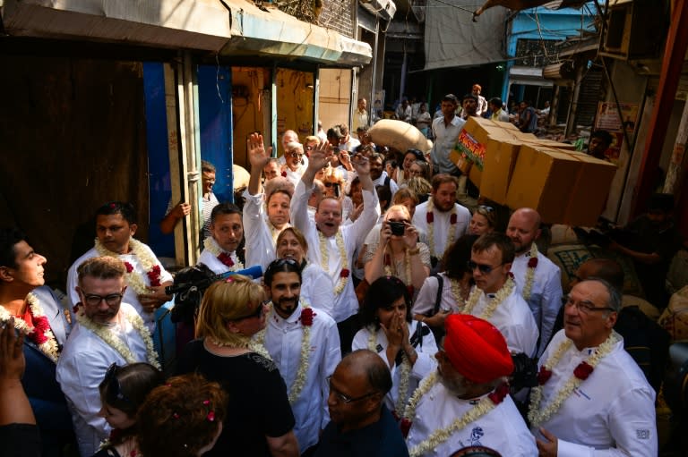 The chefs to various heads of state pose for a photograph as they visit the spice market in the old quarters of New Delhi on October 25, 2016