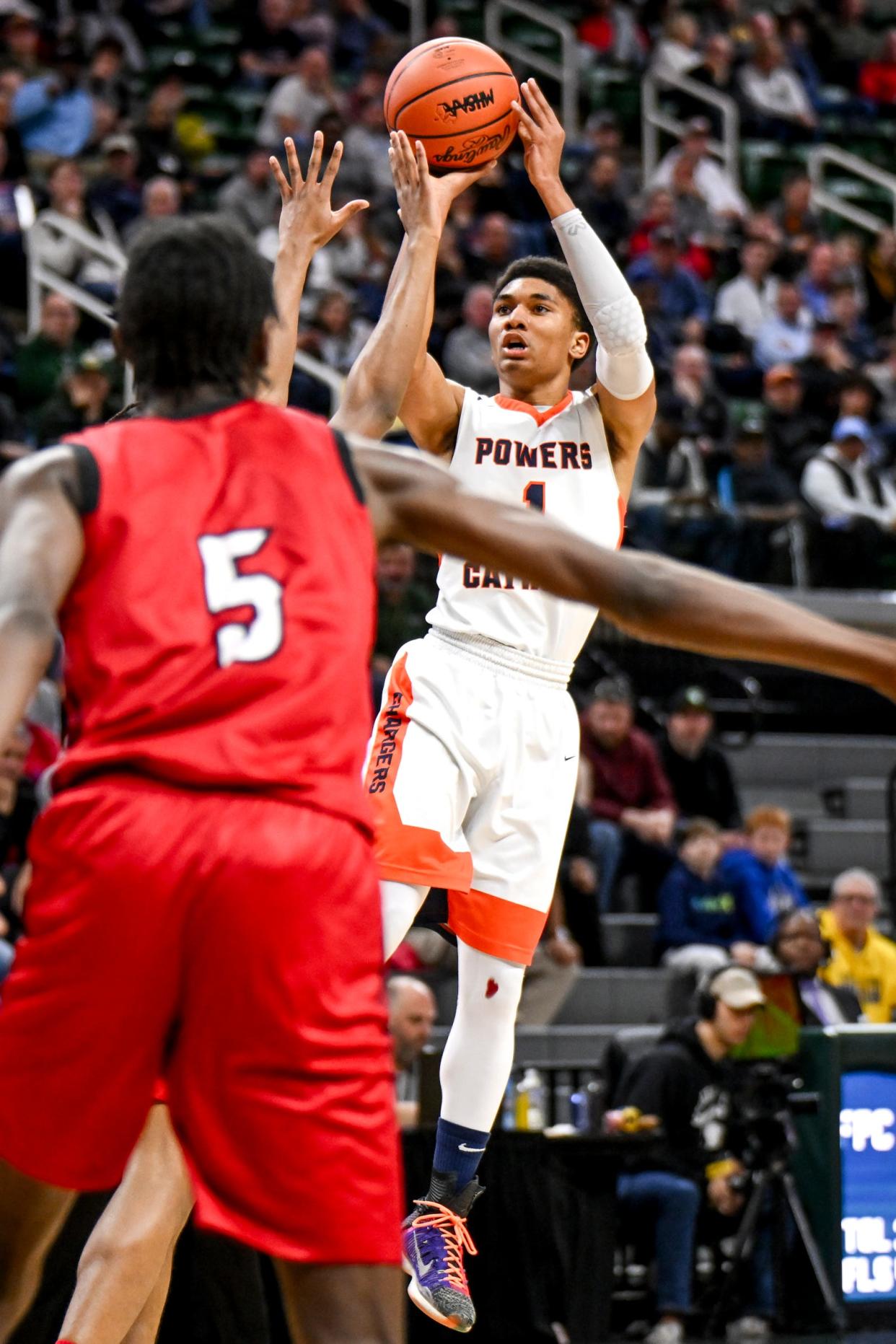 Flint Powers Catholic's Javontae Ross shoots against Warren Lincoln during the second quarter in the D2 boys basketball state semifinal on Friday, March 15, 2024, at the Breslin Center in East Lansing.