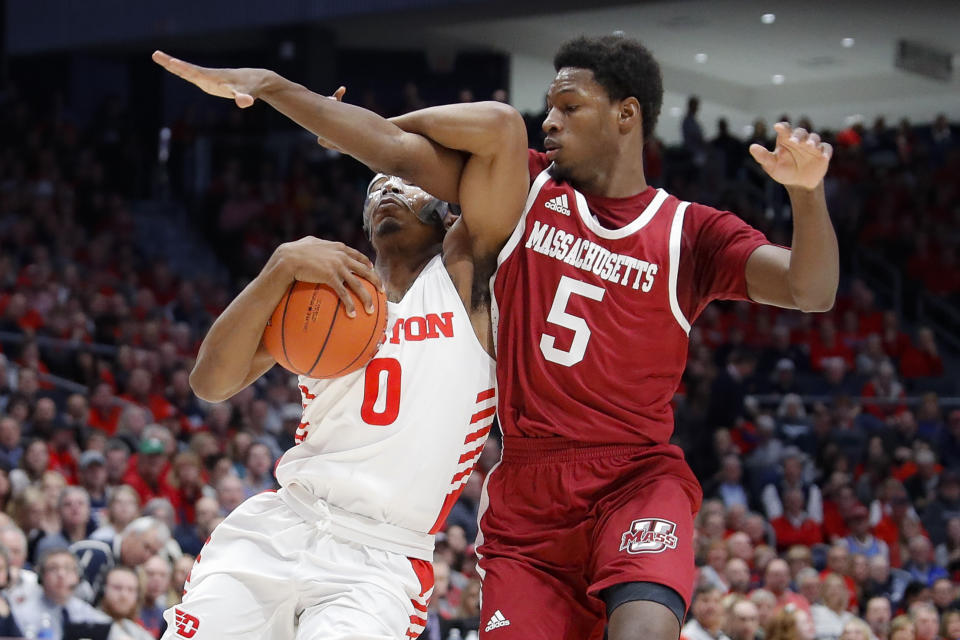 Dayton's Rodney Chatman (0) drives against Massachusetts' Samba Diallo (5) during the first half of an NCAA college basketball game, Saturday, Jan. 11, 2020, in Dayton. (AP Photo/John Minchillo)