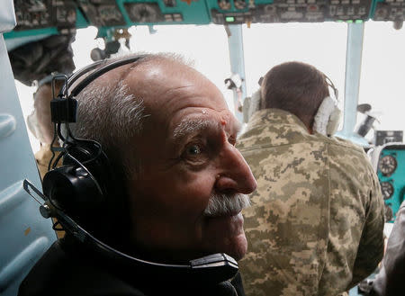 Ukrainian military pilot Mykola Volkozub, who was deployed in a team to fly a helicopter over the reactor to measure the temperature and composition of gases after the accident at the Chernobyl nuclear power plant in 1986, looks on during a flight inside a Mi-8 helicopter in Kiev Region, Ukraine April 24, 2018. REUTERS/Valentyn Ogirenko