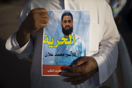 A Bedouin demonstrator holds a sign during a protest in the southern town of Rahat, Israel, in support of Islamic Jihad activist Mohammed Allan, who is in the ninth week of a hunger strike against his detention without trial, August 18, 2015. REUTERS/Amir Cohen