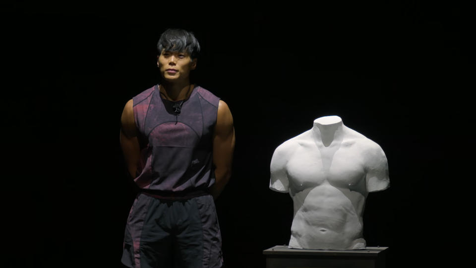 Amotti standing next to his torso sculpture in the Physical: 100 season 2 finale