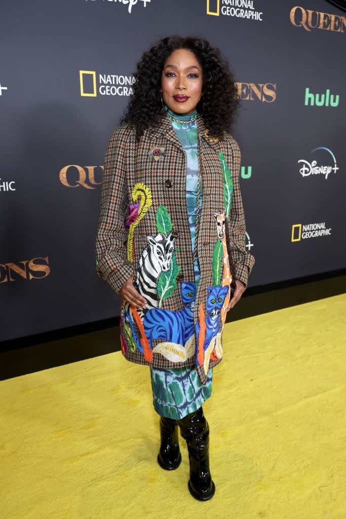 Angela Bassett on the yellow carpet, wearing an animal print dress with a plaid blazer, at a premiere event