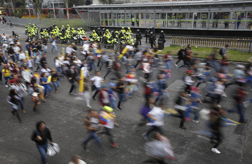 University students run during a protest asking for a hike in the budget for public higher education, in Bogota, Colombia, Thursday, Nov. 15, 2018. The so-called “Pencil March” is the latest in more than a half-dozen street protests in recent months demanding the government step up funding for education. (AP Photo/Fernando Vergara)