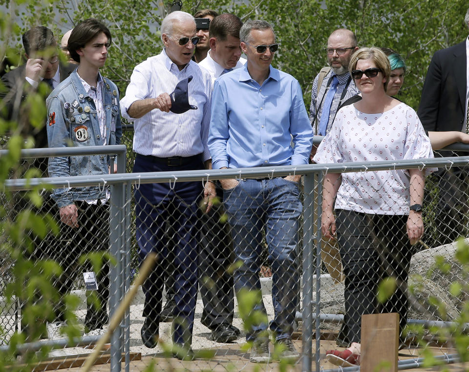 Former vice president and Democratic presidential candidate Joe Biden, second from left, views a park in Boston on Wednesday, June 5, 2019, with Bill and Denise Richard, right, and their son Henry, left, being constructed in honor of Martin Richard, the youngest victim of the 2013 Boston Marathon bombings. (AP Photo/Steven Senne)