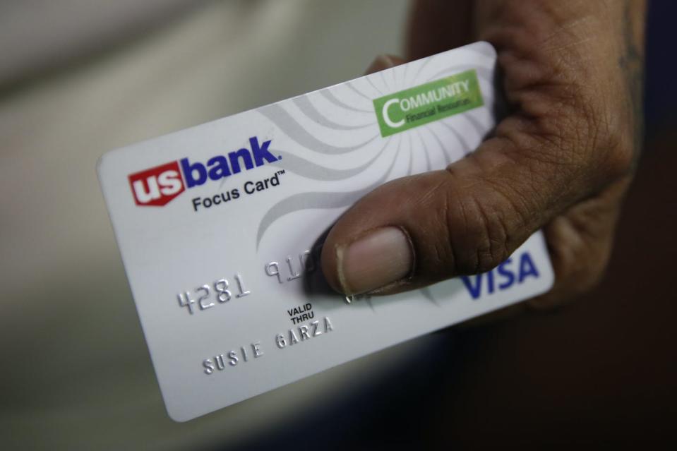 A hand holds a debit card used in the Stockton, California, basic income experiment.