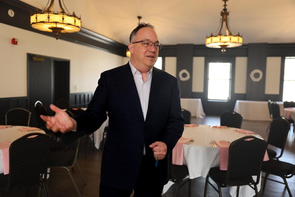 Franz Bauer, owner of the Aurora Inn, shows off the hotel and event center’s ballroom.