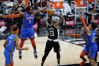 Los Angeles Clippers guard Paul George (13) shoots between Oklahoma City Thunder players, including forward Luguentz Dort (5), during the fourth quarter of an NBA basketball game Friday, Jan. 22, 2021, in Los Angeles. (AP Photo/Ashley Landis)