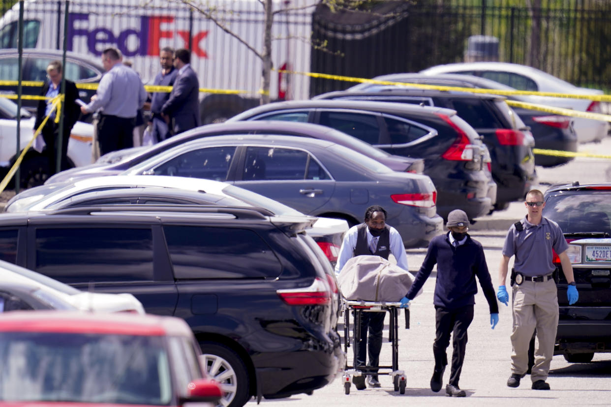 A body is taken from the scene where multiple people were shot at a FedEx Ground facility in Indianapolis, Friday, April 16, 2021. A gunman killed several people and wounded others before taking his own life in a late-night attack at a FedEx facility near the Indianapolis airport, police said. (AP Photo/Michael Conroy)