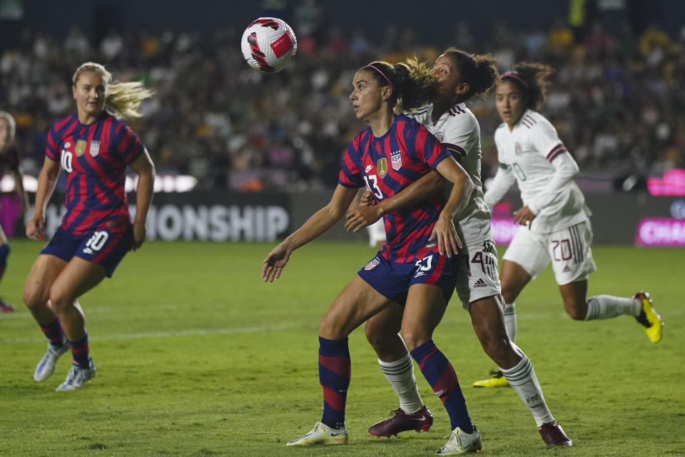 United States' Alex Morgan (13) and Mexico's Casandra Montero fight for the ball during a CONCACAF Women's Championship soccer match in Monterrey, Mexico, Monday, July 11, 2022. (AP Photo/Fernando Llano)