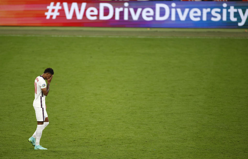 FILE - England's Marcus Rashford reacts after missing a penalty in a shootout against Italy at the Euro 2020 soccer championship final at Wembley stadium in London, Sunday, July 11, 2021. Missing penalties in a major international soccer final was bad enough for three Black players, Rashford, Jadon Sancho and Bukayo Saka, who were on England's national team. Being subjected to a torrent of racial abuse on social media in the aftermath made it even worse. (John Sibley/Pool Photo via AP, File)