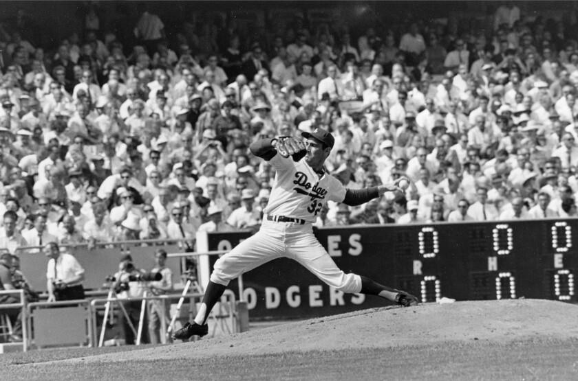 FILE - In this Oct. 6, 1966 file photo, Los Angeles Dodgers' Sandy Koufax, pitches against the Baltimore Orioles in game two of the World Series baseball game in Los Angeles.In 1965, Koufax didn't pitch the Dodgers' Series opener at Minnesota because of Yom Kippur and lost to Jim Kaat the following day. Koufax pitched a four-hit shutout on three days' rest to win Game 5, then came back with a three-hit shutout on two days' rest to win Game 7. (AP Photo/File)