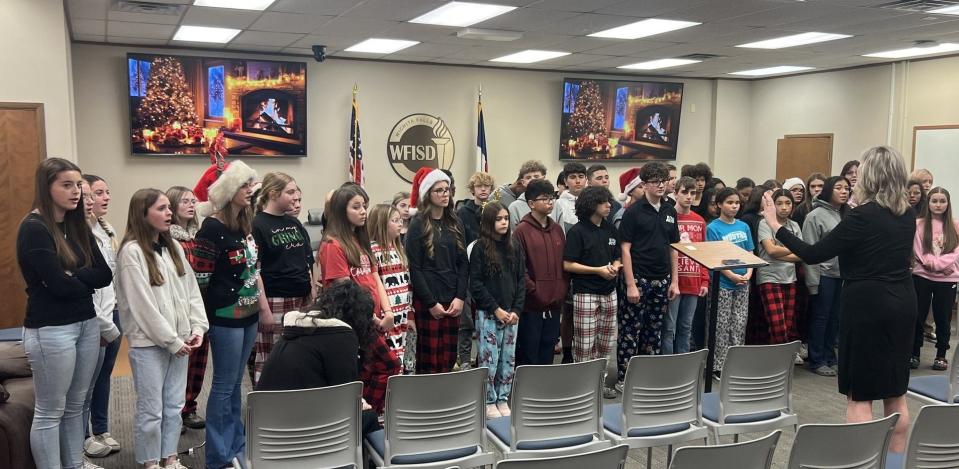 The McNiel Middle School choir members do their part to spread the Christmas spirit at the WFISD Holiday Open House Wednesday, Dec. 13, 2023.