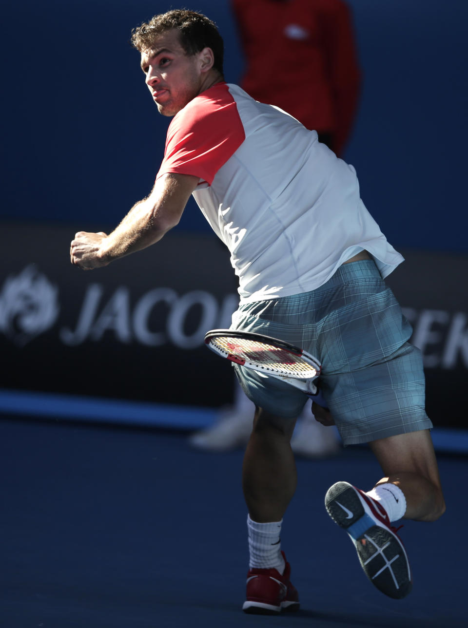 Grigor Dimitrov of Bulgaria hits a return between legs to Rafael Nadal of Spain during their quarterfinal at the Australian Open tennis championship in Melbourne, Australia, Wednesday, Jan. 22, 2014.(AP Photo/Rick Rycroft)