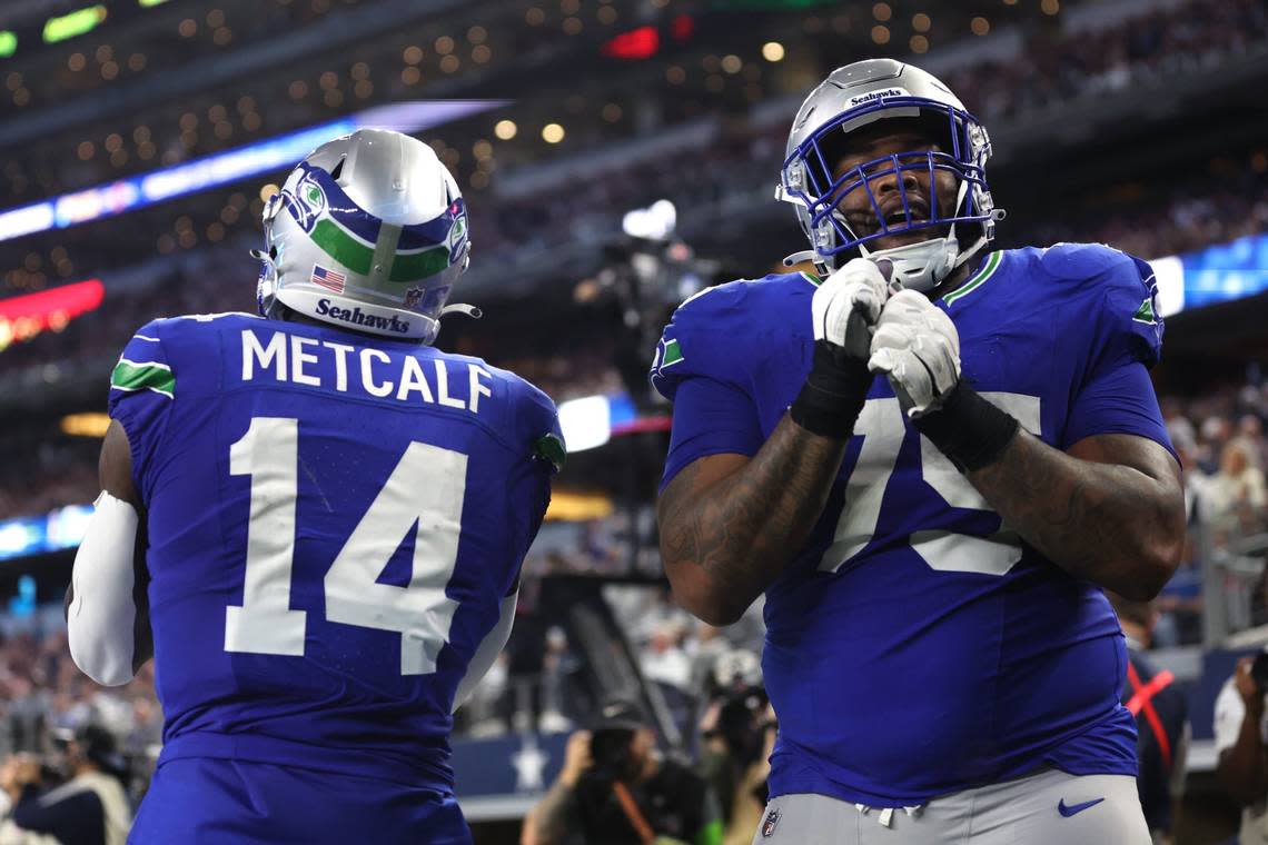 Seahawks wide receiver DK Metcalf (14) celebrates with guard Anthony Bradford (75) after scoring a touchdown against the Dallas Cowboys during the second half of their NFL game at AT&T Stadium in Arlington, Texas, Nov. 30, 2023. Tim Heitman/USA Today Sports/USA TODAY NETWORK