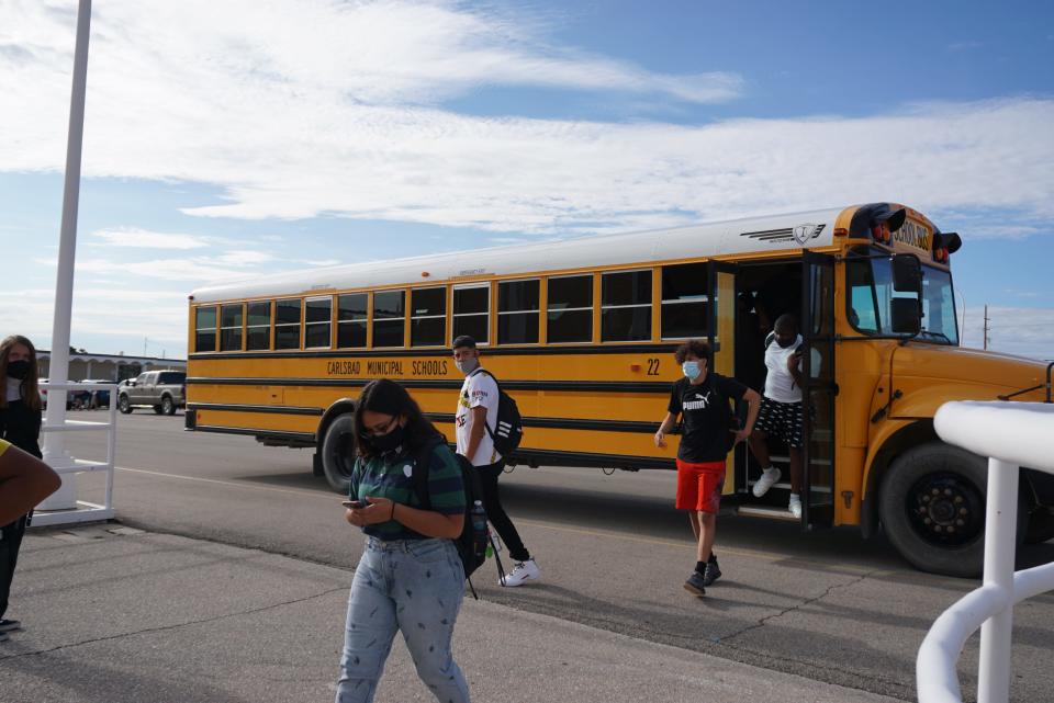 Carlsbad High School students get off the bus on Aug. 11, 2021.