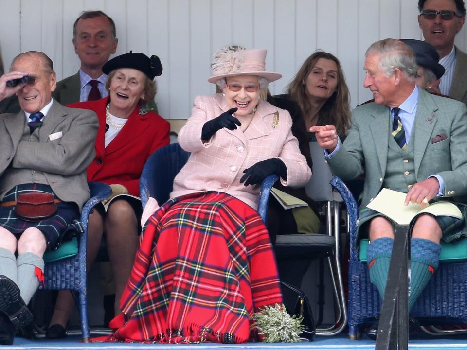 Prince Philip, Queen Elizabeth, and Prince Charles laugh at an event in Scotland